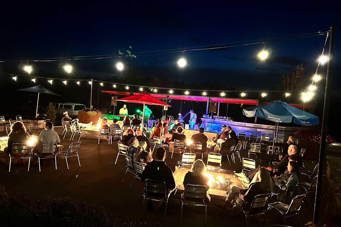 Door County Cherry Hut hosts live music outdoors at night on the heated patio beer garden